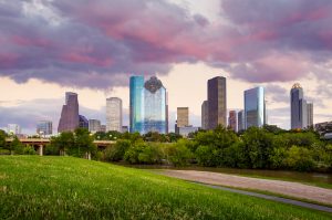 Houston, Texas skyline at sunset twilight from park lawn